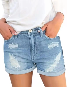 Detail of light blue distressed denim shorts featuring ripped holes and cuffed hems