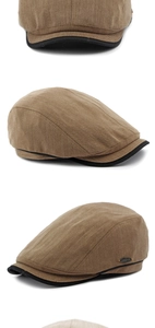 Dettaglio del cappello newsboy marrone a spina di pesce con bordo nero e logo