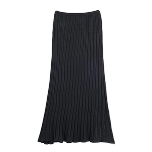 Detail of black ribbed knit midi skirt showing vertical texture and elastic waistband