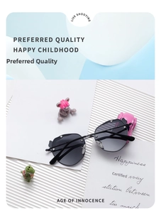Close-up of kids black polarized sunglasses with bear-shaped frames on a decorative prop set