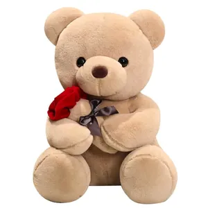 Teddy bear plush toy holding a red rose for Valentine gift, soft brown stuffed animal