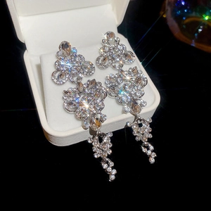 Sparkling silver drop earrings with crystals and tassels in a premium jewelry gift box