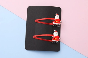 Detail of red glitter Christmas hair clips with 3D Santa Claus figure on a card set
