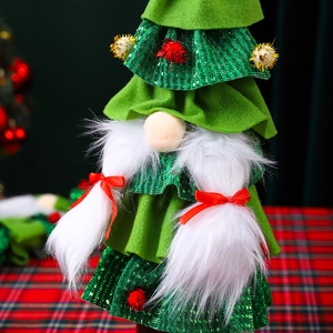 Close-up of green gnome wine bottle cover with red bow and white faux fur detail