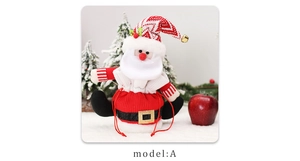 Festive Santa Claus doll gift bag with belt detail shown in a cozy Christmas snowy scene