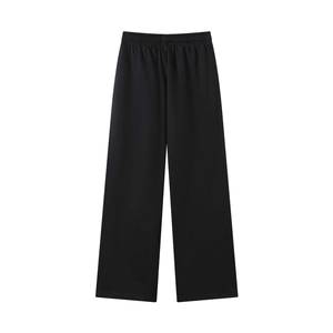 Detail of high waist elastic waistband on black wide leg pants with heavy fabric texture