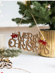 Detail of wooden Merry Christmas hanging sign with red glitter star on a tree