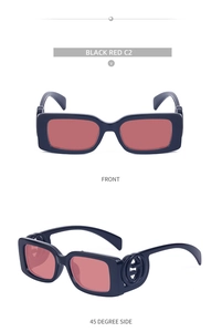 Detail of vintage square sunglasses with black frames, red lenses, and gold G-logo
