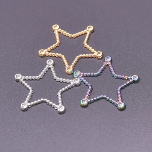 Macro detail of 18k gold and silver star pendants with sparkling inlaid zircon stones