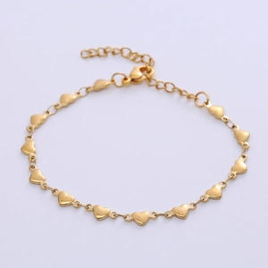 Detail view of a gold heart link bracelet with lobster clasp and adjustable chain extender