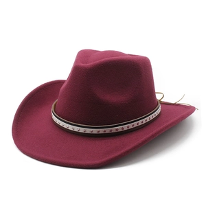Detail of dark red wool cowboy hat with star patterned band and wide curved brim