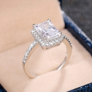 Macro detail of rectangle cut cubic zirconia engagement ring with halo pave setting