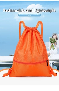 Detail of orange nylon drawstring bag with honeycomb texture and front zipper pocket
