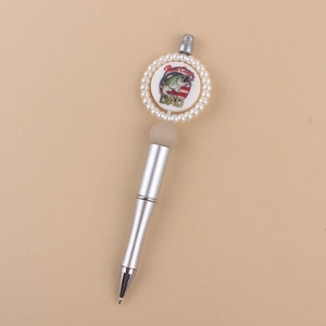 Close-up of silver beaded pen featuring a Reel Cool DAD fishing design with pearls