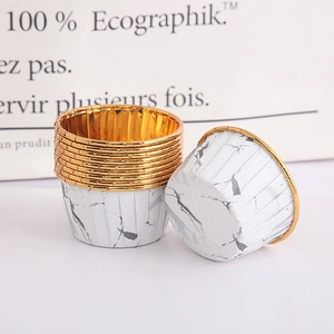 Close-up of marble pattern muffin cups with greaseproof gold foil lining for baking