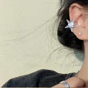 Macro shot of silver starfish ear cuff with sparkling cubic zirconia on female model