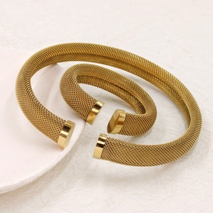 Hip hop style gold mesh titanium steel open cuff bracelets set on a pink display tray