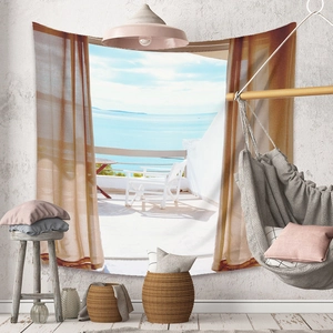 Detailed close-up of a Bohemian ocean view tapestry hanging in a minimalist living room