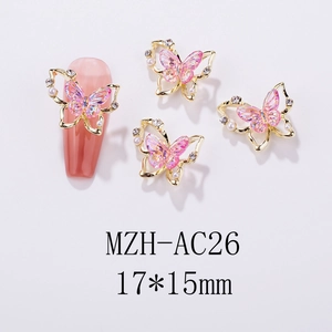 Detailed view of 17x15mm golden butterfly nail charm with pink crystals and pearls