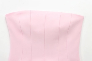 Detail view of pink tube top featuring vertical reinforced stitching and smooth fabric texture