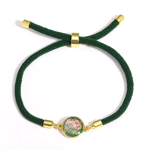Detail of adjustable green braided rope bracelet with colorful round stone inlay and gold bead