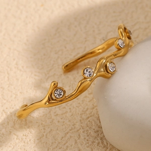 Macro shot of 18K gold plated branch bracelet with sparkling inlaid zircons