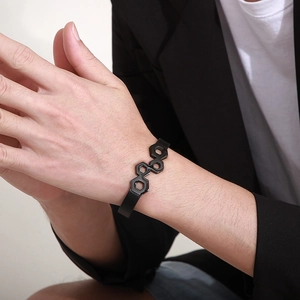Braided black leather bracelet with hexagonal stainless steel clasp shown on wrist