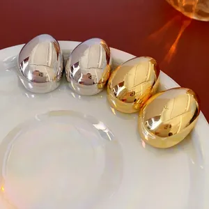 Minimalist gold and silver oval stud earrings with premium mirror polished finish