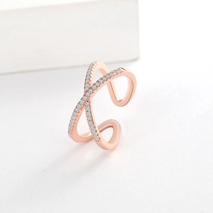 Detail of rose gold criss cross ring with sparkling white cubic zirconia pave setting
