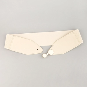 Detail of beige elastic waist belt with gold round buckle and high-stretch fabric texture