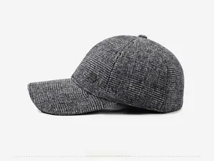 Detailed side view of grey plaid baseball cap with warm lining and hexagonal metal logo