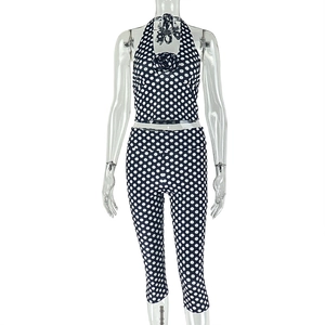 Detail of polka dot crop top with neck flower and matching slim fit leggings set