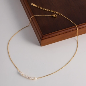 Detail of 18K gold plated stainless steel necklace with eight natural freshwater pearls