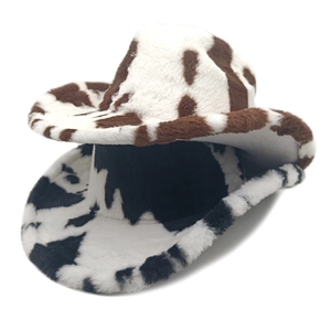 Plush cow print western cowboy hats in brown and black patterns on white background