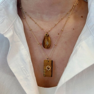 Double-layered gold beaded necklace with tiger eye stone teardrop and rectangle pendants