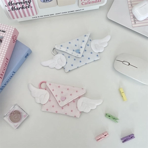 Close-up of cotton wing-shaped coin purses with star patterns and heart buttons