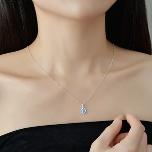 Minimalist S925 sterling silver necklace with a sky blue oval zircon pendant on a model