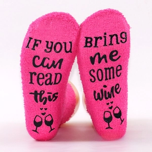 Macro view of anti-slip letter printing on warm rose pink coral fleece socks