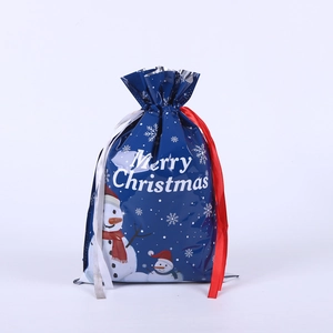 Detail of blue drawstring Christmas gift bag with snowman print and glossy finish