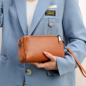 Brown genuine leather crossbody bag with lychee texture and stylish wrist strap
