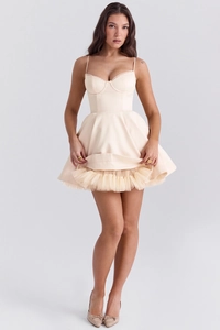 Close-up detail of cream satin mini dress featuring layered mesh tutu skirt and slim corset top