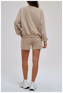Back view of khaki sweatshirt set featuring ribbed cuffs and back pocket detail