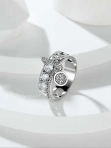 Macro view of silver ring featuring a round disc pendant set with sparkling zircon stones