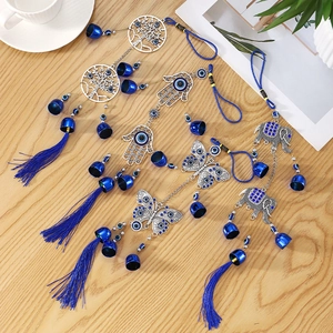 Evil Eye wind chimes set with Hamsa Hand and Tree of Life on wooden table