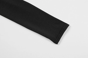 Macro detail of high-quality flat-stitched cuff on a black long sleeve bodycon dress