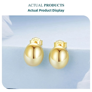 Detailed macro of gold S925 sterling silver bean stud earrings with hallmark stamp