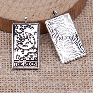 Detailed view of silver Tarot Moon pendant showing both front and back engraving details