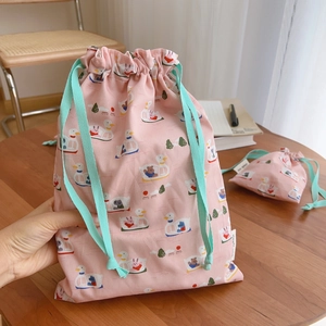 Pink cotton drawstring bag featuring cute cartoon duck prints and a woven label