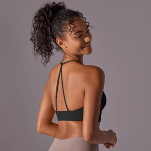 Detail of cross-back straps on black sports bra with professional athletic fit