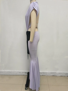 Detail of purple fishtail dress with waist cutout and elegant ruched texture design